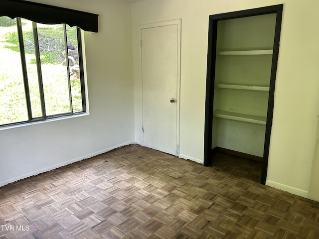 unfurnished bedroom featuring parquet floors