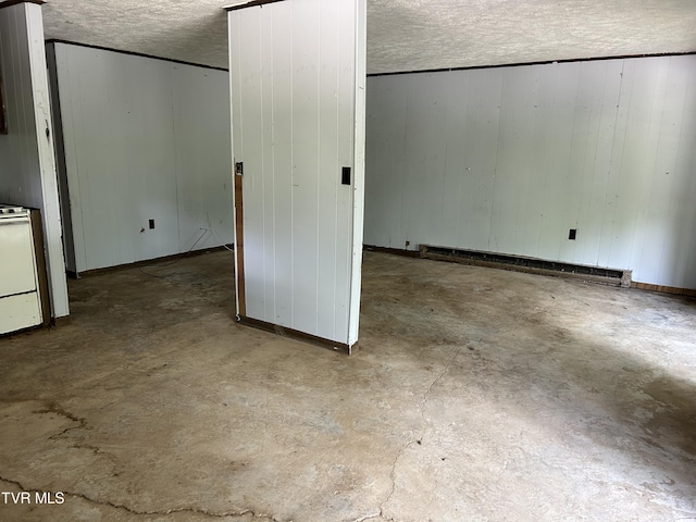 interior space with a baseboard radiator and wood walls