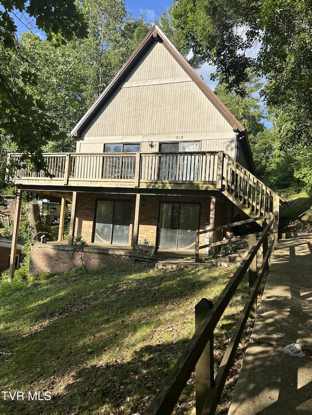 back of house with a wooden deck