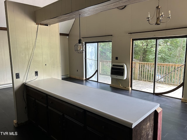 kitchen featuring a healthy amount of sunlight, heating unit, an inviting chandelier, and decorative light fixtures