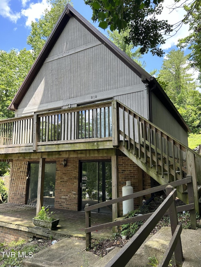 view of property exterior featuring a patio area and a deck