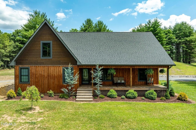 log cabin featuring a porch and a front lawn