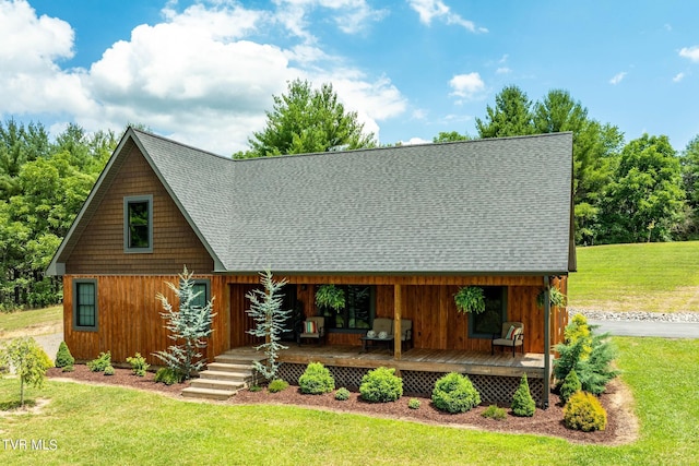 view of front of property with covered porch and a front lawn