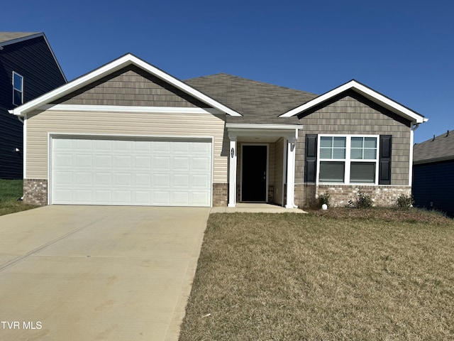 craftsman-style house featuring a front yard, a garage, and driveway