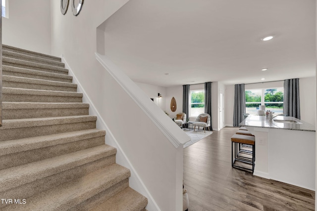 stairway featuring wood-type flooring