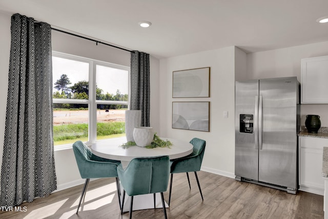 dining space with light wood-type flooring