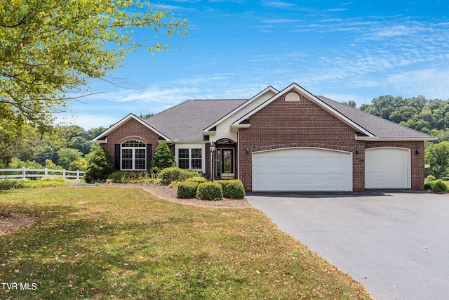 view of front facade with a garage and a front yard