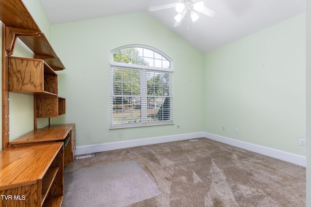 unfurnished office featuring lofted ceiling, carpet flooring, and ceiling fan