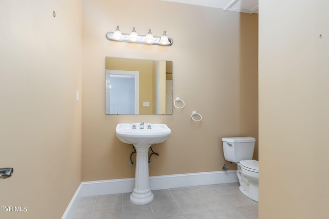 bathroom with tile patterned floors and toilet