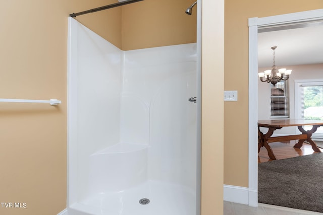 bathroom with a chandelier and walk in shower