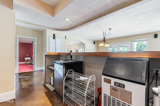 kitchen featuring pendant lighting and a textured ceiling