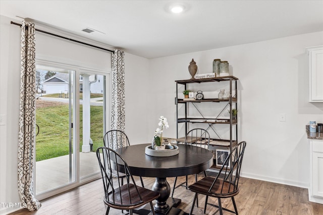 dining space with light wood-type flooring