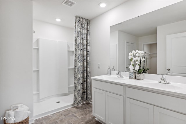 bathroom featuring vanity and curtained shower