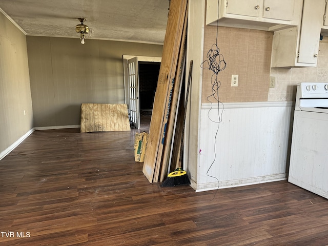 kitchen featuring washer / clothes dryer, dark wood-type flooring, and white cabinets