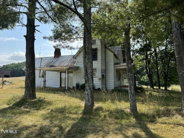 view of home's exterior with a lawn