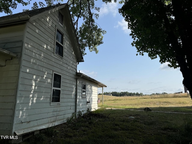 view of side of home featuring a rural view