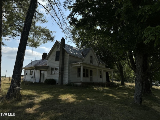 view of property exterior with a lawn