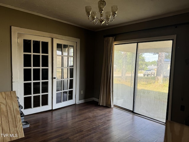 interior space featuring french doors, ornamental molding, dark hardwood / wood-style floors, and a notable chandelier