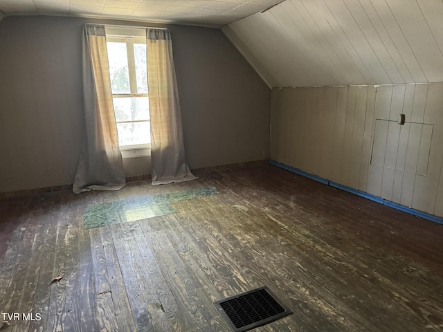 bonus room with lofted ceiling and dark wood-type flooring