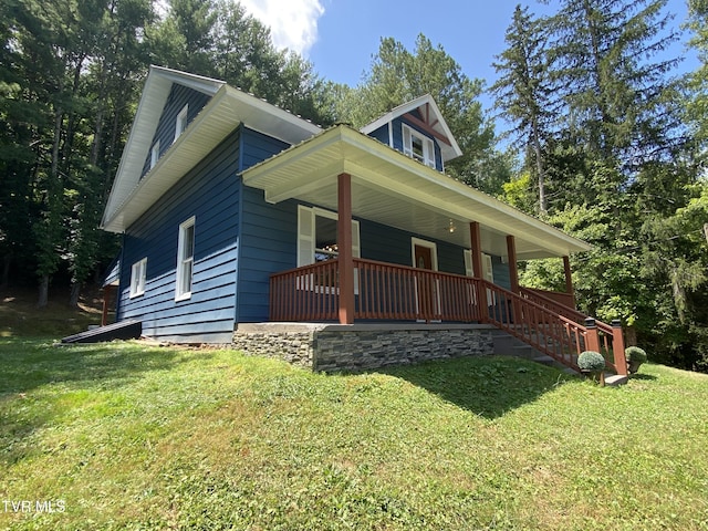 view of front of home featuring a front yard and a porch