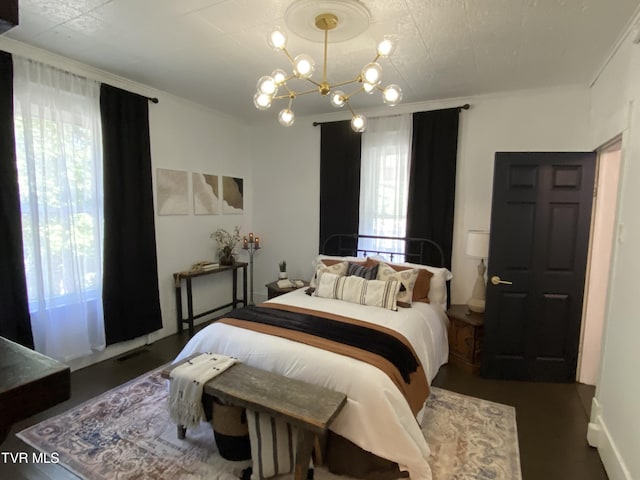 bedroom featuring an inviting chandelier and ornamental molding