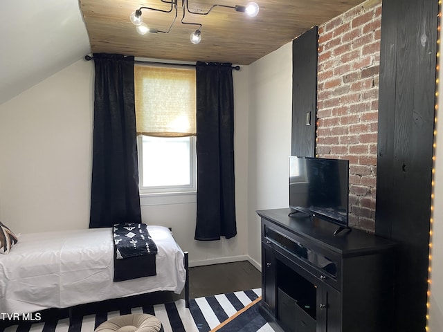 bedroom with dark wood-type flooring, vaulted ceiling, and wood ceiling