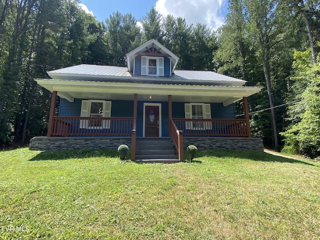 bungalow-style house featuring covered porch and a front lawn