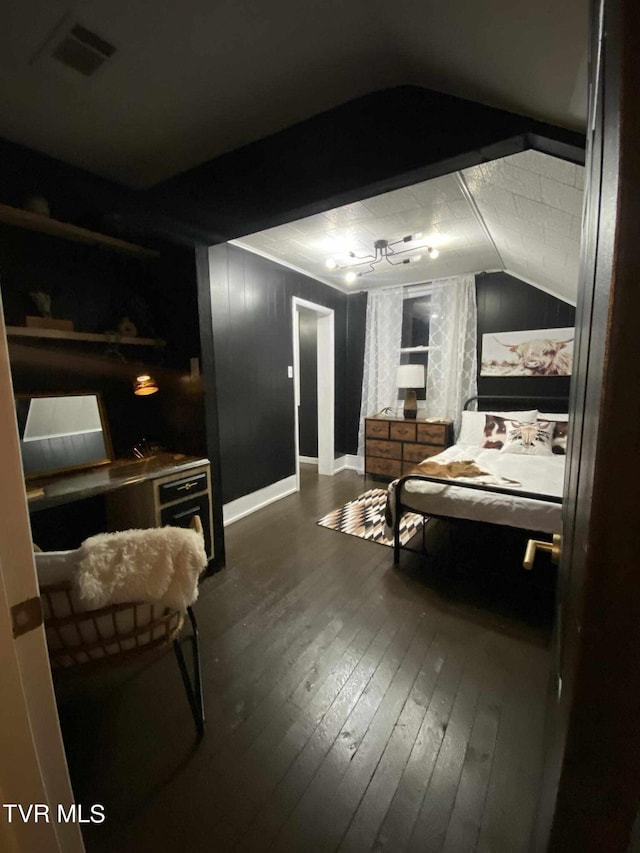 bedroom with vaulted ceiling and dark hardwood / wood-style floors