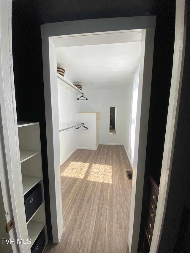 spacious closet featuring hardwood / wood-style floors