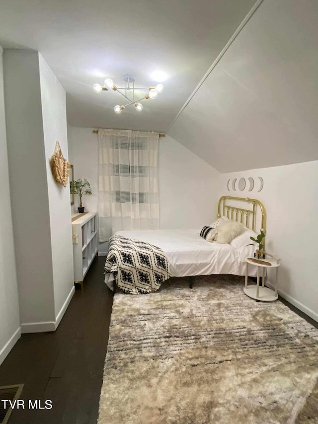 bedroom with dark wood-type flooring and vaulted ceiling