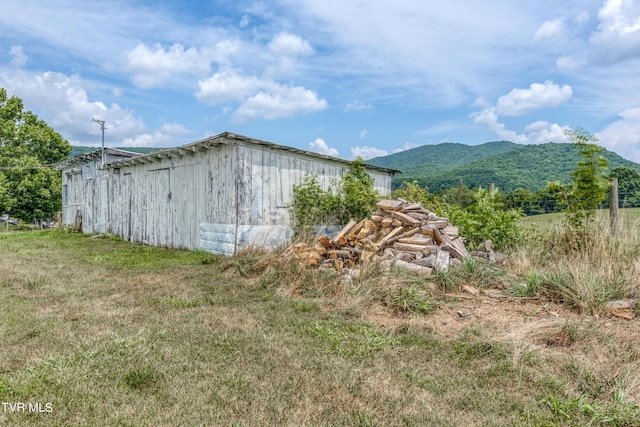 exterior space with a mountain view and a yard