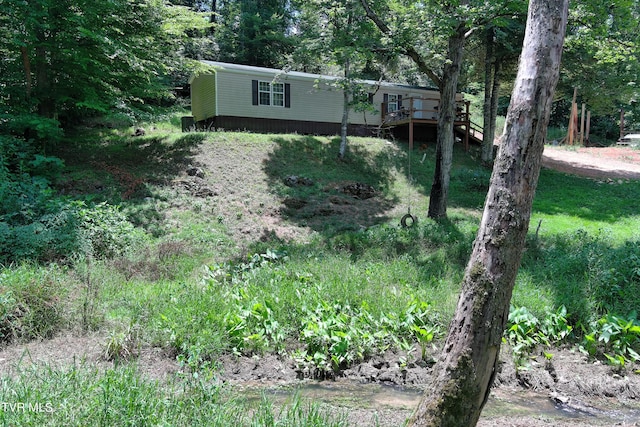 view of yard featuring a deck with water view