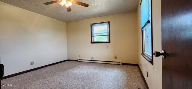 carpeted empty room with ceiling fan, a baseboard heating unit, and a textured ceiling