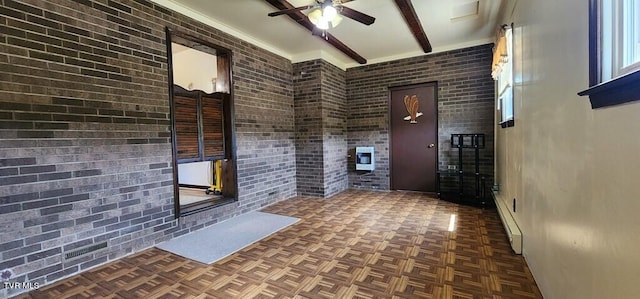 interior space with beamed ceiling, dark parquet flooring, and brick wall