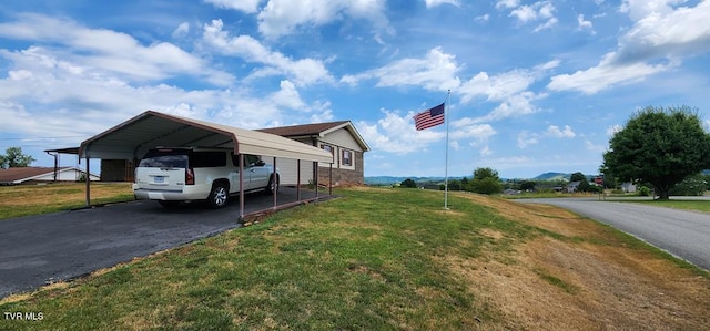 view of side of home with a yard and a carport