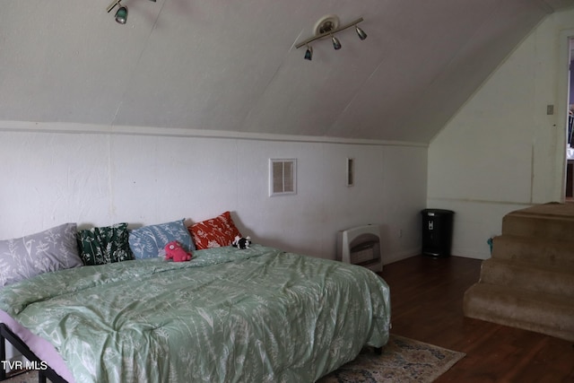 bedroom with dark wood-type flooring and vaulted ceiling