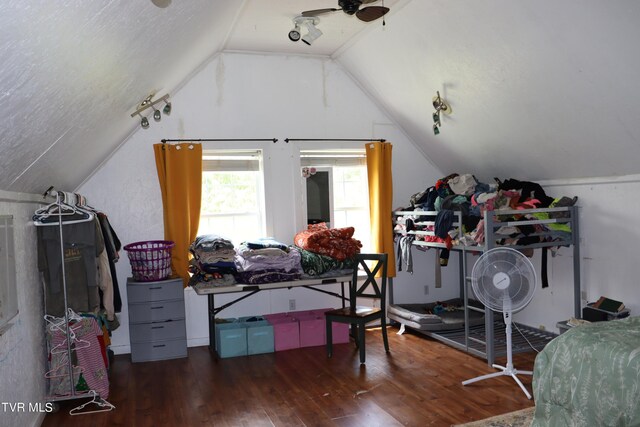 additional living space with lofted ceiling, ceiling fan, dark wood-type flooring, and a textured ceiling