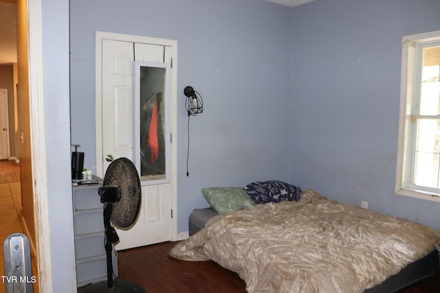 bedroom with dark wood-type flooring