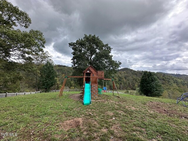 2497 Upper Copper Creek Rd, Castlewood, VA 24224 - view of playground with a mountain view, a forest view, and fence
