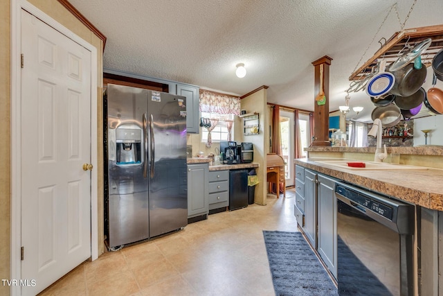 kitchen with stainless steel refrigerator with ice dispenser, sink, gray cabinetry, a textured ceiling, and dishwasher