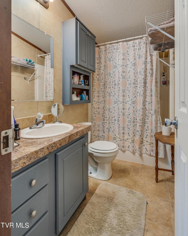 full bathroom featuring tile patterned flooring, vanity, toilet, a textured ceiling, and shower / bath combo with shower curtain