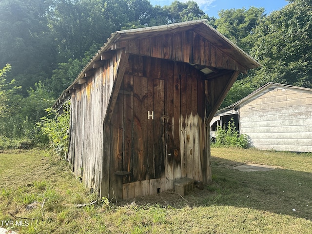 view of outbuilding with a yard