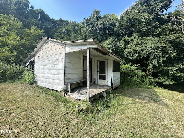 view of outbuilding featuring a yard