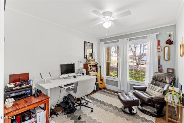 home office featuring crown molding, wood finished floors, ceiling fan, and a wealth of natural light