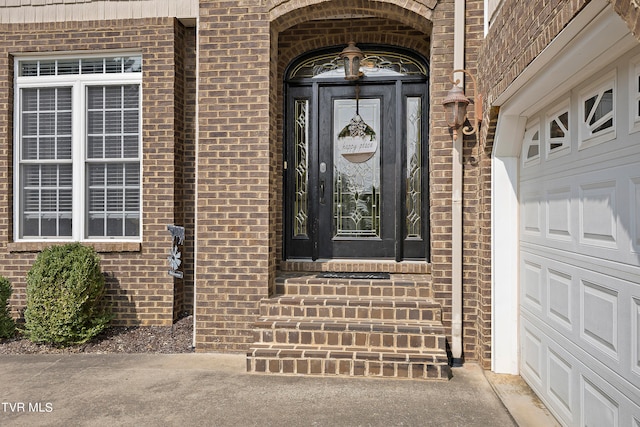 view of exterior entry with a garage