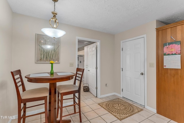 dining room with light tile patterned floors and a textured ceiling