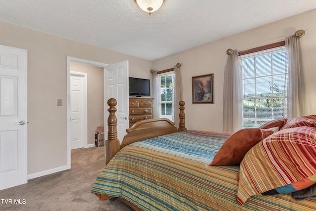 carpeted bedroom with a textured ceiling