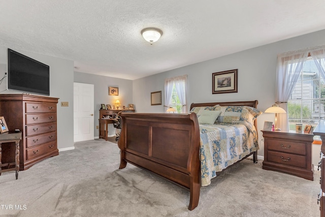 carpeted bedroom with a textured ceiling