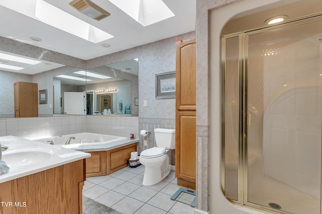 full bathroom featuring toilet, tile patterned floors, vanity, a skylight, and independent shower and bath