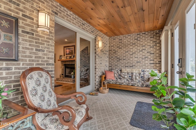 sunroom / solarium with a fireplace and wooden ceiling